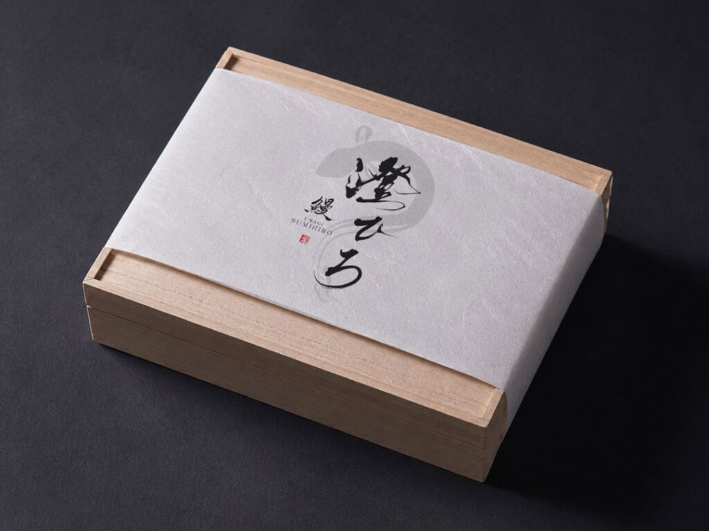Japanese brush logo design applied to unagi bento packaging